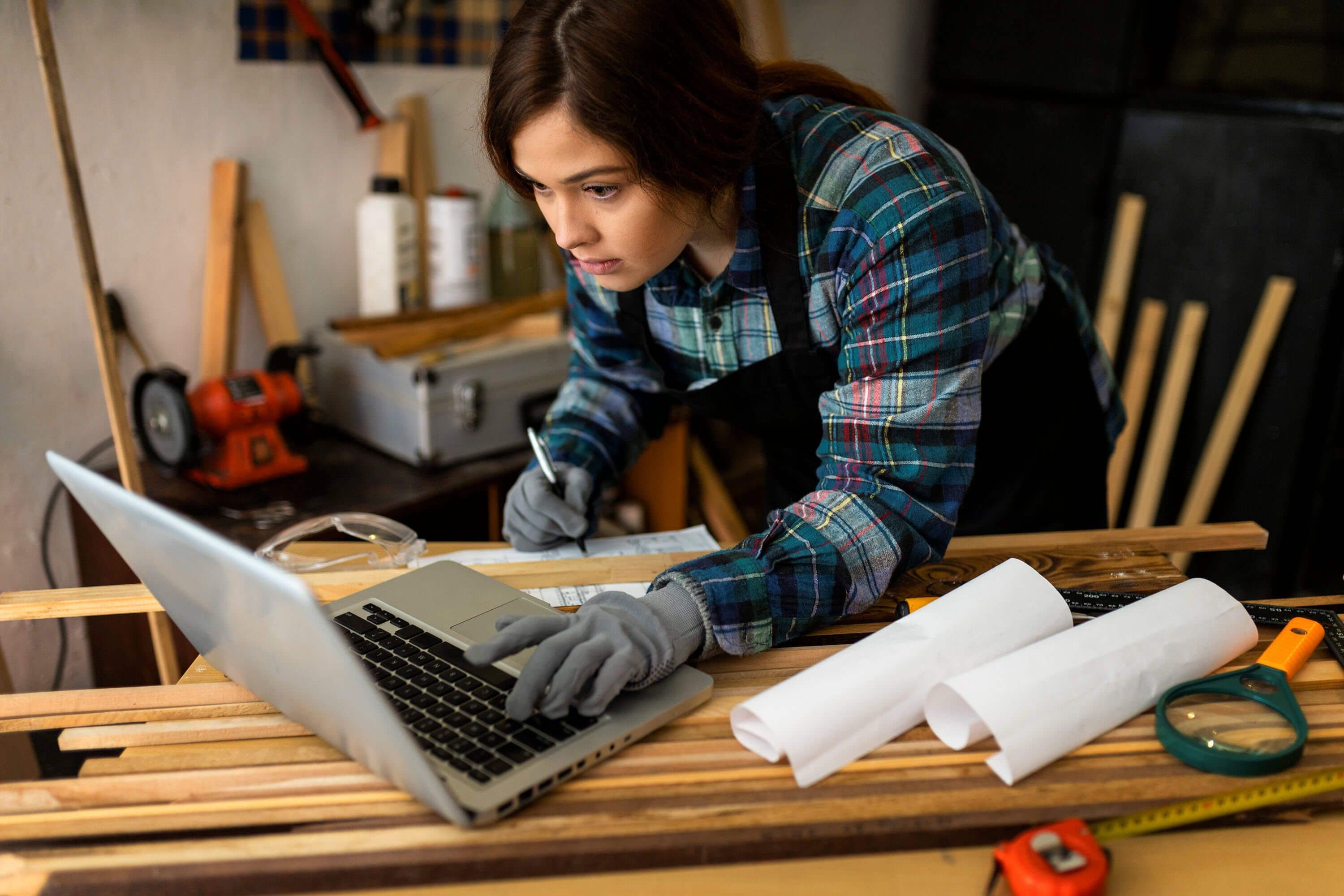 Female working in workshop using laptop